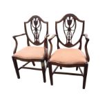 A pair of Victorian Hepplewhite style mahogany armchairs, the shield shaped backs with pierced
