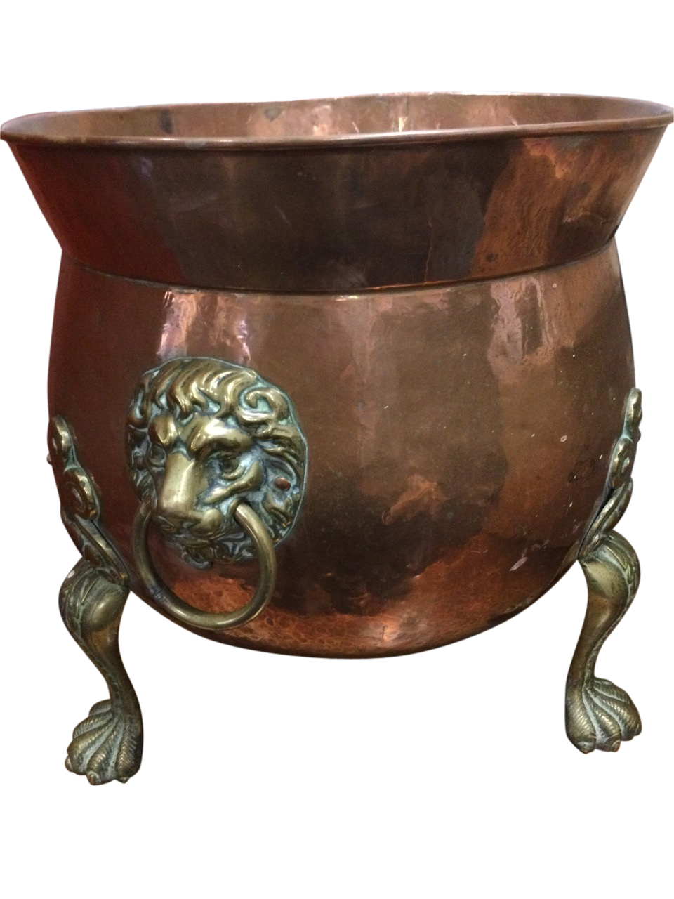 A cauldron shaped copper log bin with flared rim above hammered body mounted with lionmask ring