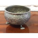 An Indian silver bowl with gadroon moulded rim above body embossed with foliate scrolled frieze,