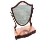 A mahogany dressing table mirror with shield shaped plate on tapering supports above a bowfronted