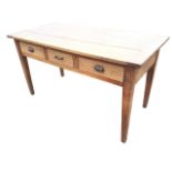 A Victorian pine table, the cleated plank top above three ribbed frieze drawers, raised on square