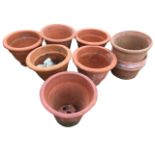 Two pairs of terracotta garden pots with ribbed and incised decoration; and five others -