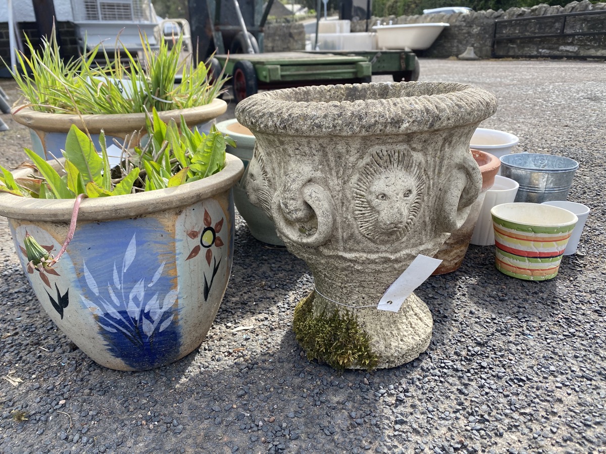 A composition stone urn moulded with rings & lionheads; three glazed garden plantpots; and other