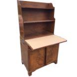 A mahogany secretaire bookcase with open shelves above a turn-over crossbanded top with baize