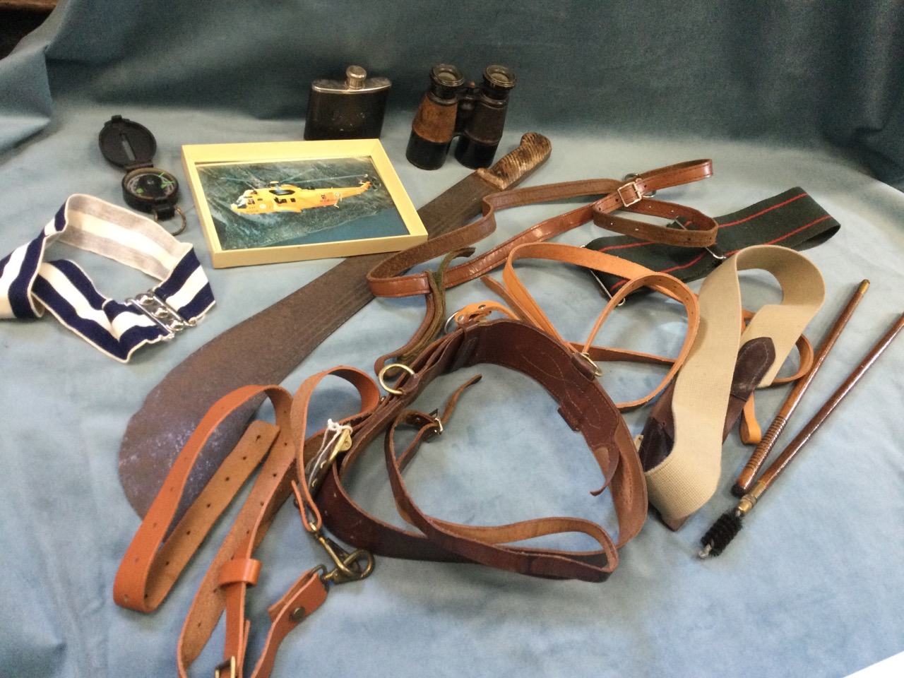 A large ancient machete; various military belts & straps; a pair of gun cleaning rods; a compass;