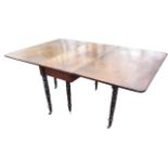 A nineteenth century mahogany dining table, the rectangular top with two drop leaves raised on