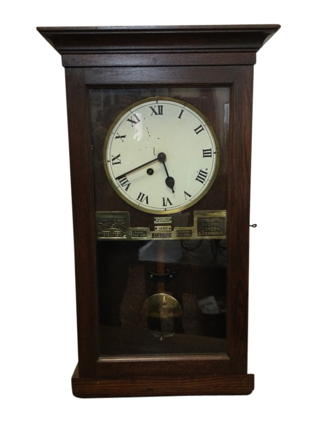 An Edwardian oak cased wallclock - reputedly from Rothbury Station, with moulded cornice above