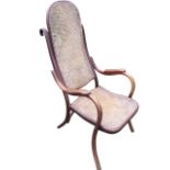 A C20th Thonet bentwood armchair, with rounded high back above shaped arms with armrests, raised