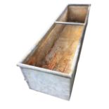 A rectangular 6ft galvanised trough with tubular rim. (73in)