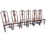 A set of six George II style oak dining chairs having moulded back rails on turned columns framing