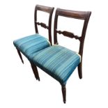 A pair of nineteenth century mahogany chairs with tablet panelled back rails on ribbed stiles, the