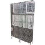 A pair of cage type lockers, each with four rectangular hinged doors having internal hooks. (23.75in