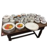 A Stonehenge Midwinter dinner/breakfast service decorated with bright orange flowers on speckled