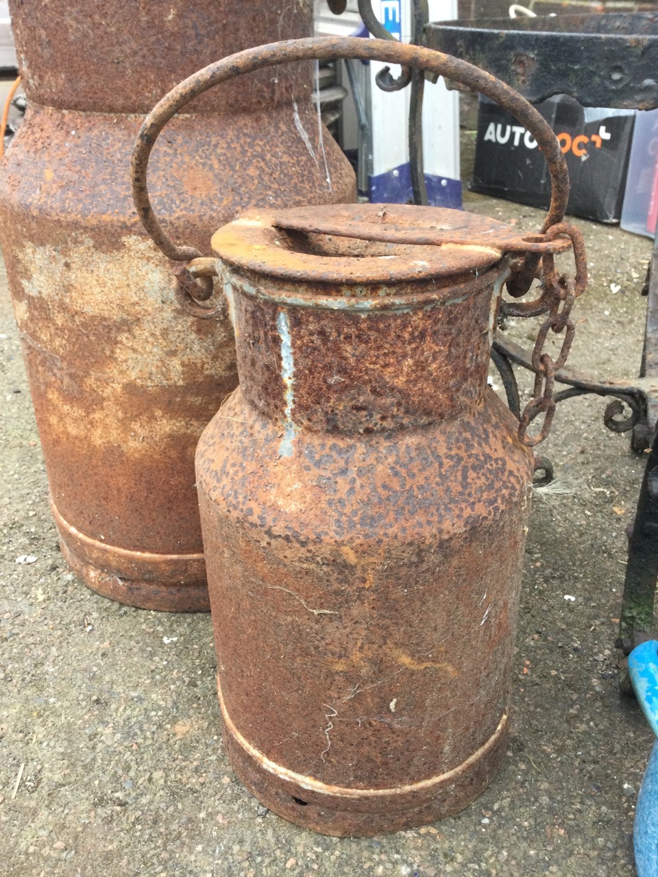 A graduated pair of ancient milk churns & covers with swing handles; a circular wrought iron pot - Image 2 of 3