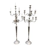 A pair of 6ft silver plated candelabra, each with eight scrolled branches supported urn shaped