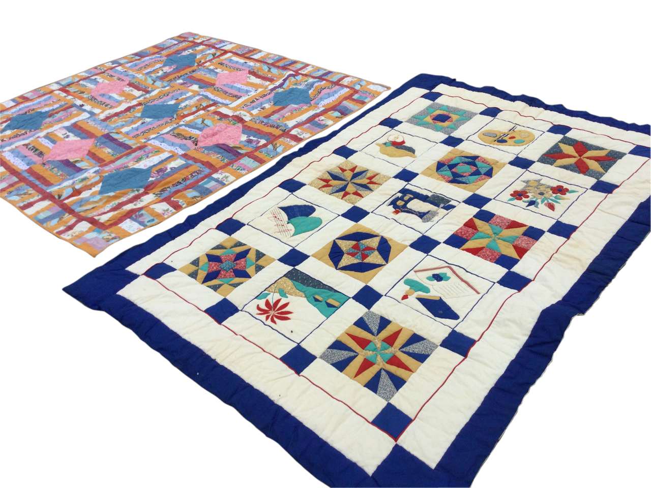 A South African cotton patchwork quilt sewn with colourful panels around square lozenges - 81in x