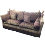 A Knole house two/three-seater sofa with shaped drop arms and loose cushions, upholstered in