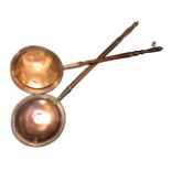 A nineteenth century copper bedwarming pan with domed hinged lid, mounted on turned hardwood handle;