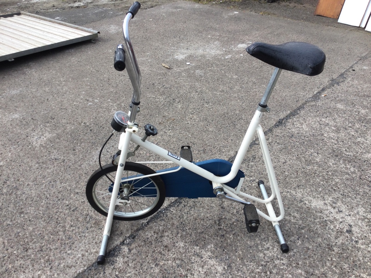 A Terry exercise bicycle on stand with adjustable padded seat and handlebars, having tension dial