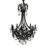 A large belle epoche glass beaded chandelier, the eight scrolled branches supporting candlelights on