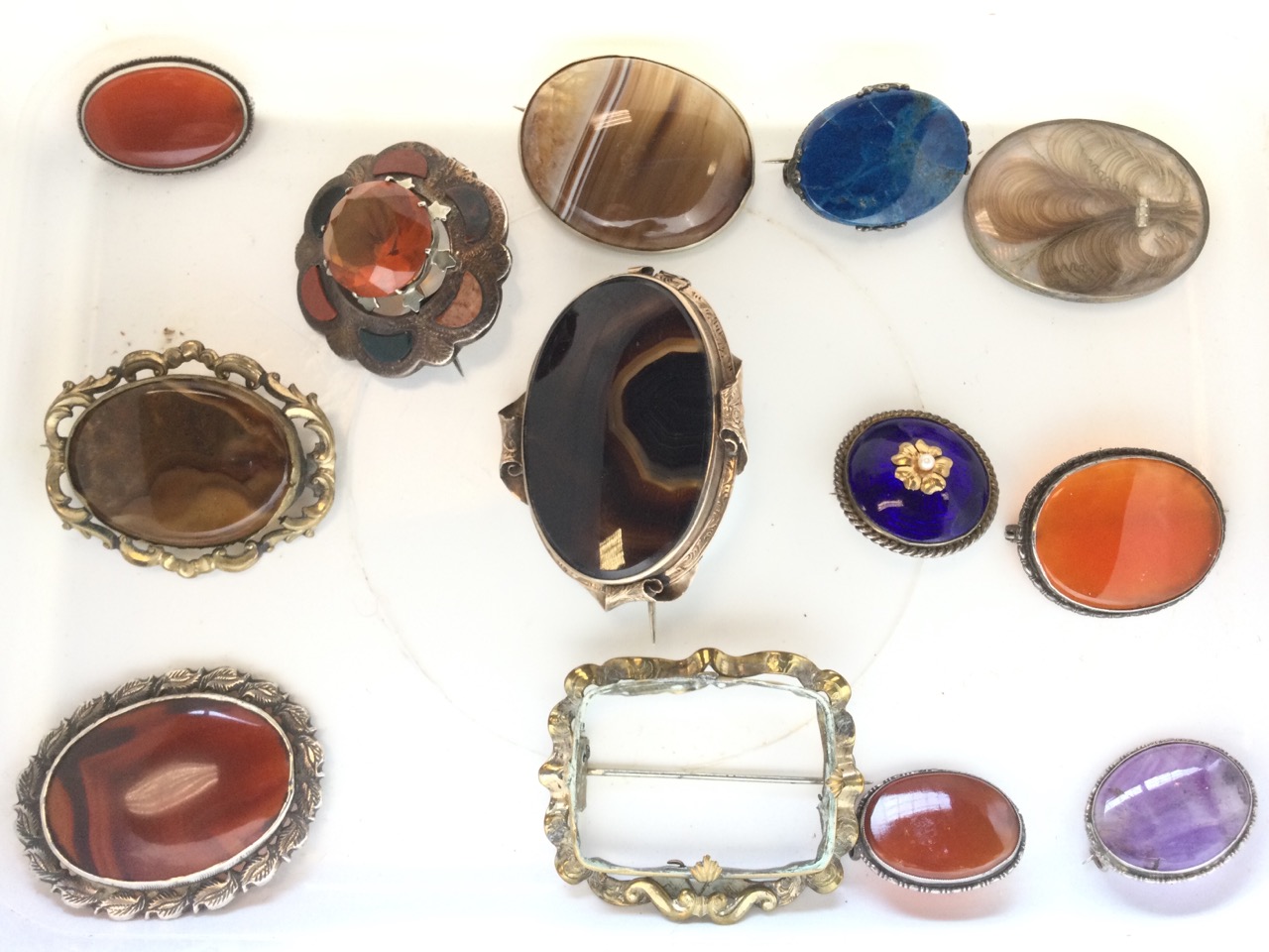 Twelve oval Victorian cabochon shaped brooches & pendants, silver & yellow metal, amber, polished