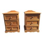 A pair of pine bedside cabinets with shaped upstands to moulded tops, each having three panelled