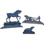 A Victorian cast iron flatback horse doorstop on moulded plinth; another with horse & ploughman