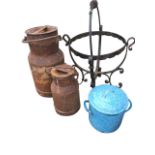 A graduated pair of ancient milk churns & covers with swing handles; a circular wrought iron pot