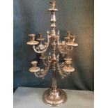 A silver plated candelabra, the fluted column supporting two tiers of four scrolled branches