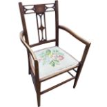 An Edwardian mahogany armchair inlaid with boxwood stringing, with fretwork cut back and shaped arms