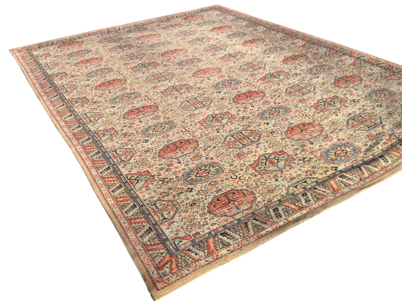 An Axminster carpet woven with field of rectangular octagonal medallions on fawn ground, within a