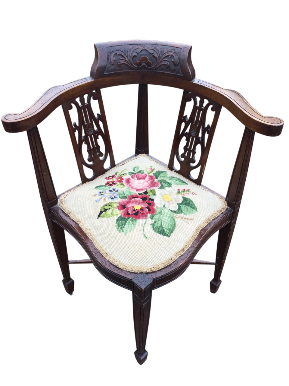 A mahogany corner chair with foliate scroll carved crest to back rail, having pierced fretwork