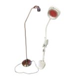A magnifying electric reading light with adjustable arm on column stand with various attachments;