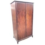 A Stag mahogany wardrobe having interior with hanging space, drawers and shelves, the fielded