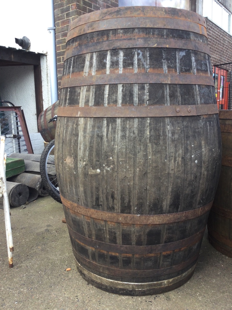 A large oak whiskey barrel, the staves bound by ten riveted metal strap bands. (51in) - Image 3 of 3