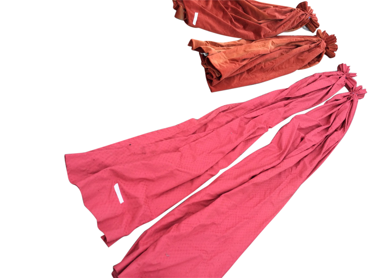 A pair of red velvet lined curtains - 52in; and a pair of long red embossed cotton curtains -