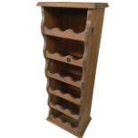 A “pennyman” pine wine rack with moulded top above open shelves to take 18 bottles. (14.5in x 9in