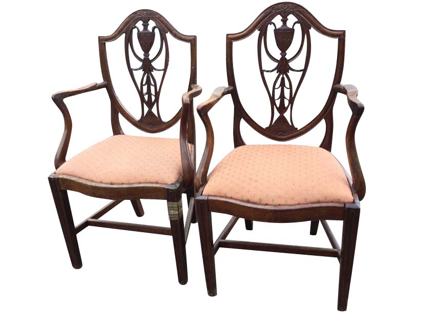 A pair of Victorian Hepplewhite style mahogany armchairs, the shield shaped backs with pierced