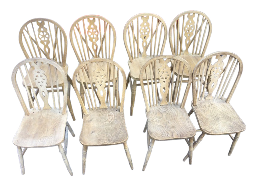 A married set of eight wheelback kitchen chairs, the arched backs on spindles with pierced splats