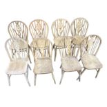 A married set of eight wheelback kitchen chairs, the arched backs on spindles with pierced splats