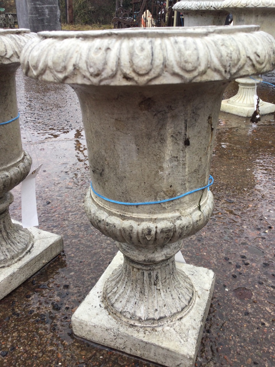 A pair of composition resin garden urns with lozenge moulded rims on fluted tapering bodies, with - Image 2 of 3