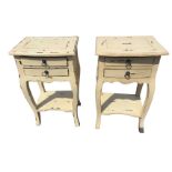 A pair of painted bowfronted bedside tables, the panelled moulded tops above two small drawers
