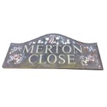 A rectangular sign handpainted & moulded in relief with flowers, in moulded frame. (56in x 26.5in)