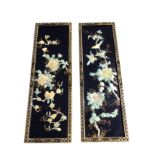 A pair of Japanese lacquered panels inlaid with mother of pearl birds and peony blossom foliage on