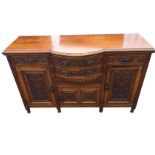 A Victorian carved walnut sideboard, the bowfronted central section with two drawers above a