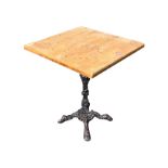 A square pub type table with hardwood top on cast iron foliate moulded column, the scrolled base