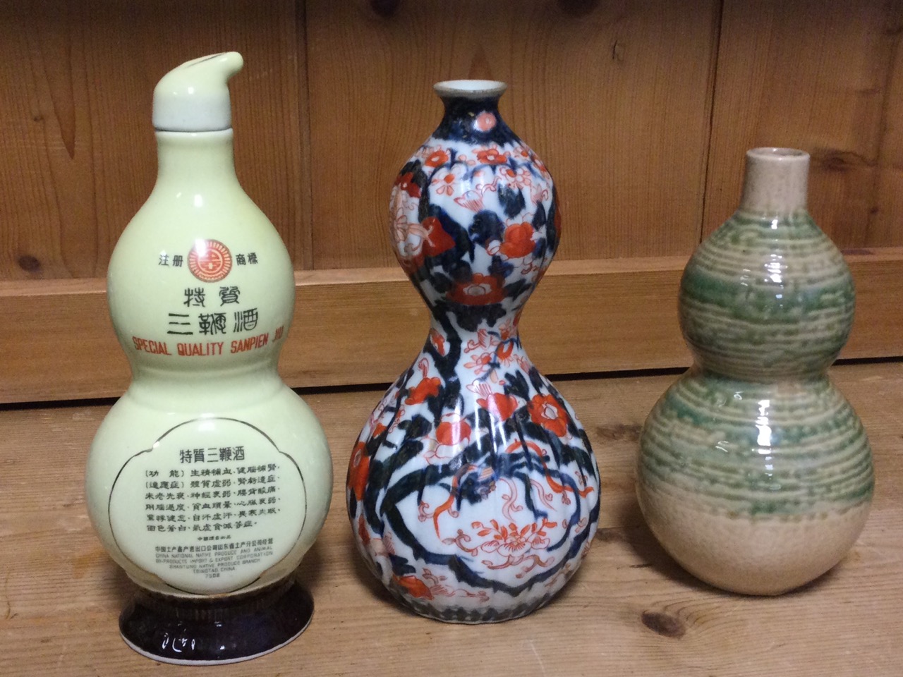 Three gourd shaped ceramic vases - ribbed and decorated in the Imari palette, mottled sancai type - Image 3 of 3