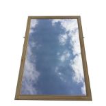 A rectangular contemporary pine framed mirror in cushion moulded frame. (27in x 39in)