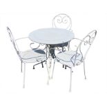 A circular white painted metal garden table with three armchairs, the chairs with rounded backs