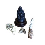 An ebonised buddha on circular carved hardwood stand; a model of a lady pulling a vegetable cart;